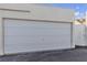 Exterior view of the home's garage door and pedestrian gate at 5400 Paul Kurtz Way # 105, Las Vegas, NV 89108
