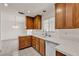 Well-lit kitchen featuring wood cabinets, white tile countertops, and a white sink at 5400 Paul Kurtz Way # 105, Las Vegas, NV 89108