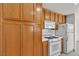 Bright kitchen boasting wooden cabinets, a white microwave, and a range oven at 5400 Paul Kurtz Way # 105, Las Vegas, NV 89108