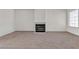 Open living room featuring a fireplace and neutral-colored carpet at 5400 Paul Kurtz Way # 105, Las Vegas, NV 89108
