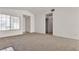Bright living room with large window allowing natural light, neutral paint and carpet throughout the space at 5400 Paul Kurtz Way # 105, Las Vegas, NV 89108