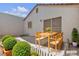 Back patio staged with a dining table and lush greenery at 5400 Paul Kurtz Way # 105, Las Vegas, NV 89108