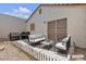 Staged back patio with outdoor sofa, chairs and grill at 5400 Paul Kurtz Way # 105, Las Vegas, NV 89108