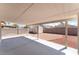Covered back patio and gravel backyard featuring a storage shed and privacy walls for low-maintenance outdoor living at 5524 La Pelusa St, North Las Vegas, NV 89031