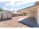 Enclosed backyard featuring a patio, gravel landscaping and a storage shed at 5524 La Pelusa St, North Las Vegas, NV 89031