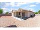 Private backyard featuring low-maintenance gravel landscaping, a covered patio and a privacy wall at 5524 La Pelusa St, North Las Vegas, NV 89031