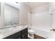 Well-lit bathroom featuring a modern vanity with stone countertops and a shower-tub combo at 5524 La Pelusa St, North Las Vegas, NV 89031