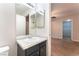 Bathroom with a modern vanity, framed mirror, and an entryway to a walk in closet at 5524 La Pelusa St, North Las Vegas, NV 89031