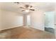 Bright, carpeted bedroom with ceiling fan and two entryways to ensuite bathroom and closet at 5524 La Pelusa St, North Las Vegas, NV 89031