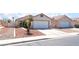 Attractive single-story home with a two-car garage, a concrete driveway, and minimal landscaping at 5524 La Pelusa St, North Las Vegas, NV 89031