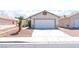 Lovely single-story home with a two-car garage, a concrete driveway, and desert landscaping at 5524 La Pelusa St, North Las Vegas, NV 89031