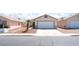 Inviting single-story home featuring a two-car garage, a concrete driveway, and desert landscaping at 5524 La Pelusa St, North Las Vegas, NV 89031