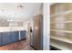 Contemporary kitchen featuring stainless steel appliances, modern lighting, and an adjacent pantry at 5524 La Pelusa St, North Las Vegas, NV 89031