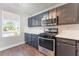 Cozy kitchen featuring stainless steel appliances, painted cabinets, and a bright window for natural light at 5524 La Pelusa St, North Las Vegas, NV 89031