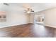 Spacious living area with wood floors, ceiling fan and sliding glass door with backyard access at 5524 La Pelusa St, North Las Vegas, NV 89031