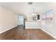 Open-concept living space with sleek wood floors, modern lighting and view into entry and kitchen at 5524 La Pelusa St, North Las Vegas, NV 89031