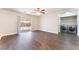 Bright living room with wood floors, ceiling fan, slider and laundry closet at 5524 La Pelusa St, North Las Vegas, NV 89031