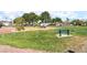 Community playground with lush green grass, mature trees, seating, and colorful play structures for Gathering fun at 5524 La Pelusa St, North Las Vegas, NV 89031