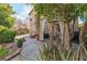 Expansive backyard blends decorative plantings with an outdoor dining area and an entertainment space at 556 Caribbean Palm Dr, Las Vegas, NV 89138