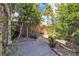 Charming backyard featuring flagstone accents, lush vegetation, mature trees, and decorative hanging pots at 556 Caribbean Palm Dr, Las Vegas, NV 89138