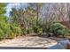 Landscaped backyard featuring a paved patio area with flower beds and a cozy seating arrangement at 556 Caribbean Palm Dr, Las Vegas, NV 89138
