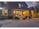 Beautiful backyard patio with seating, string lights, and a view into the modern interior at 556 Caribbean Palm Dr, Las Vegas, NV 89138