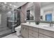 Contemporary bathroom with double vanity, modern fixtures, glass shower and sleek tiled walls at 556 Caribbean Palm Dr, Las Vegas, NV 89138