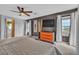 Spacious bedroom with dark accent wall, ample natural light, sleek furniture, and ceiling fan at 556 Caribbean Palm Dr, Las Vegas, NV 89138