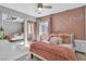 Stylish bedroom features a mirrored closet, warm colors, plush bedding, and soft, ambient lighting at 556 Caribbean Palm Dr, Las Vegas, NV 89138