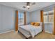 Comfortable bedroom with plush bedding, ceiling fan, and natural light from two bright windows at 556 Caribbean Palm Dr, Las Vegas, NV 89138