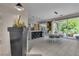 Elegant dining area blending seamlessly with a modern kitchen and offering an open view to the backyard at 556 Caribbean Palm Dr, Las Vegas, NV 89138