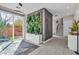Elegant entryway featuring a modern plant wall, tiled floors, and a staircase leading to the upper level at 556 Caribbean Palm Dr, Las Vegas, NV 89138