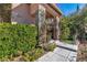 Charming front porch with decorative pillars, lush greenery, and a cozy entrance, showcasing the property's character at 556 Caribbean Palm Dr, Las Vegas, NV 89138