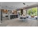 Bright, modern kitchen featuring an island with seating and stainless steel appliances, with easy access to outdoor patio at 556 Caribbean Palm Dr, Las Vegas, NV 89138