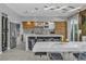 Modern kitchen with stainless steel appliances, a large island, and a custom wine rack at 556 Caribbean Palm Dr, Las Vegas, NV 89138