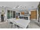 Spacious eat-in kitchen featuring modern lighting, an island with bar seating, and custom cabinets at 556 Caribbean Palm Dr, Las Vegas, NV 89138