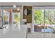 Outdoor patio view through sliding glass doors, featuring a covered seating area and lush landscaping at 556 Caribbean Palm Dr, Las Vegas, NV 89138