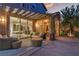 Inviting outdoor patio with stylish seating, overlooking the home's interior through a sliding glass door at 556 Caribbean Palm Dr, Las Vegas, NV 89138