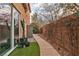 A landscaped side yard showcases a concrete pathway, desert plants, a storage shed, and privacy wall at 556 Caribbean Palm Dr, Las Vegas, NV 89138