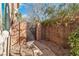 Private side yard featuring a pathway, gravel landscaping, block wall, and gated access to the backyard at 556 Caribbean Palm Dr, Las Vegas, NV 89138