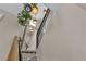 Modern stairwell with sleek black railings and natural light, creating an open and inviting space at 556 Caribbean Palm Dr, Las Vegas, NV 89138