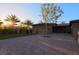 Backyard features a brick-paved patio, lush lawn, mature trees, and desert landscaping at 6110 Pebble Glen Ct, Las Vegas, NV 89149