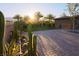 Landscaped backyard with lush desert foliage, stone patio, and bright sunshine at 6110 Pebble Glen Ct, Las Vegas, NV 89149