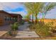 Beautiful backyard with manicured landscaping, featuring stone walkway and desert plants at 6110 Pebble Glen Ct, Las Vegas, NV 89149