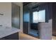 Modern bathroom featuring herringbone tile floors, a frameless glass shower, and stylish fixtures at 6110 Pebble Glen Ct, Las Vegas, NV 89149