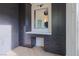 Dressing room with custom cabinets, countertops, vanity mirror and herringbone floors at 6110 Pebble Glen Ct, Las Vegas, NV 89149