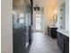 Elegant bathroom with herringbone tile floors, double vanities, modern fixtures and glass enclosed shower at 6110 Pebble Glen Ct, Las Vegas, NV 89149