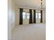 Spacious bedroom showcasing neutral carpet, recessed lights, and large windows with curtains at 6110 Pebble Glen Ct, Las Vegas, NV 89149