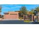 Well-maintained home featuring a two-car garage, desert landscaping, and decorative gated entry at 6110 Pebble Glen Ct, Las Vegas, NV 89149