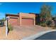 Stylish home with a two-car garage, desert landscaping, and a brick driveway at 6110 Pebble Glen Ct, Las Vegas, NV 89149